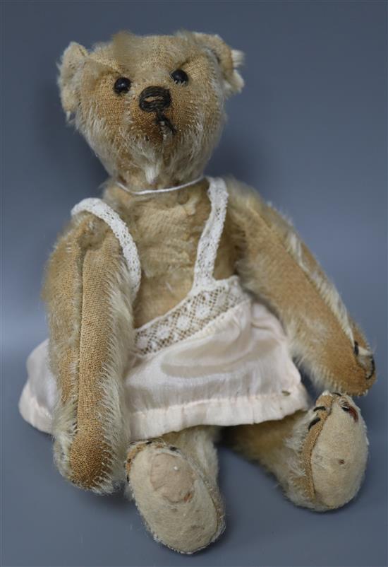 A vintage Steiff c1908 with button in ear, some hair loss generally, height 20cm